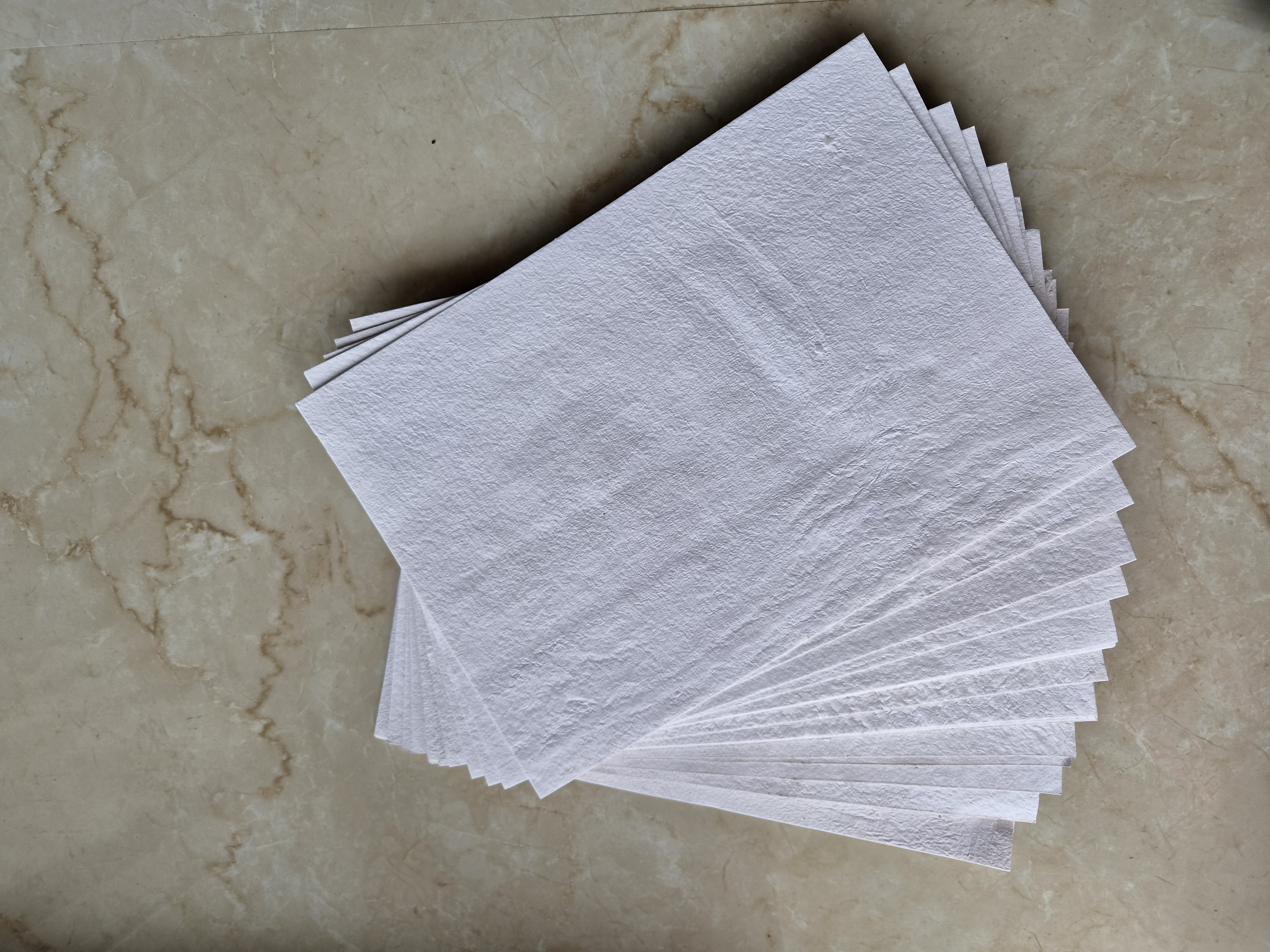 White handmade paper sheets — hero
