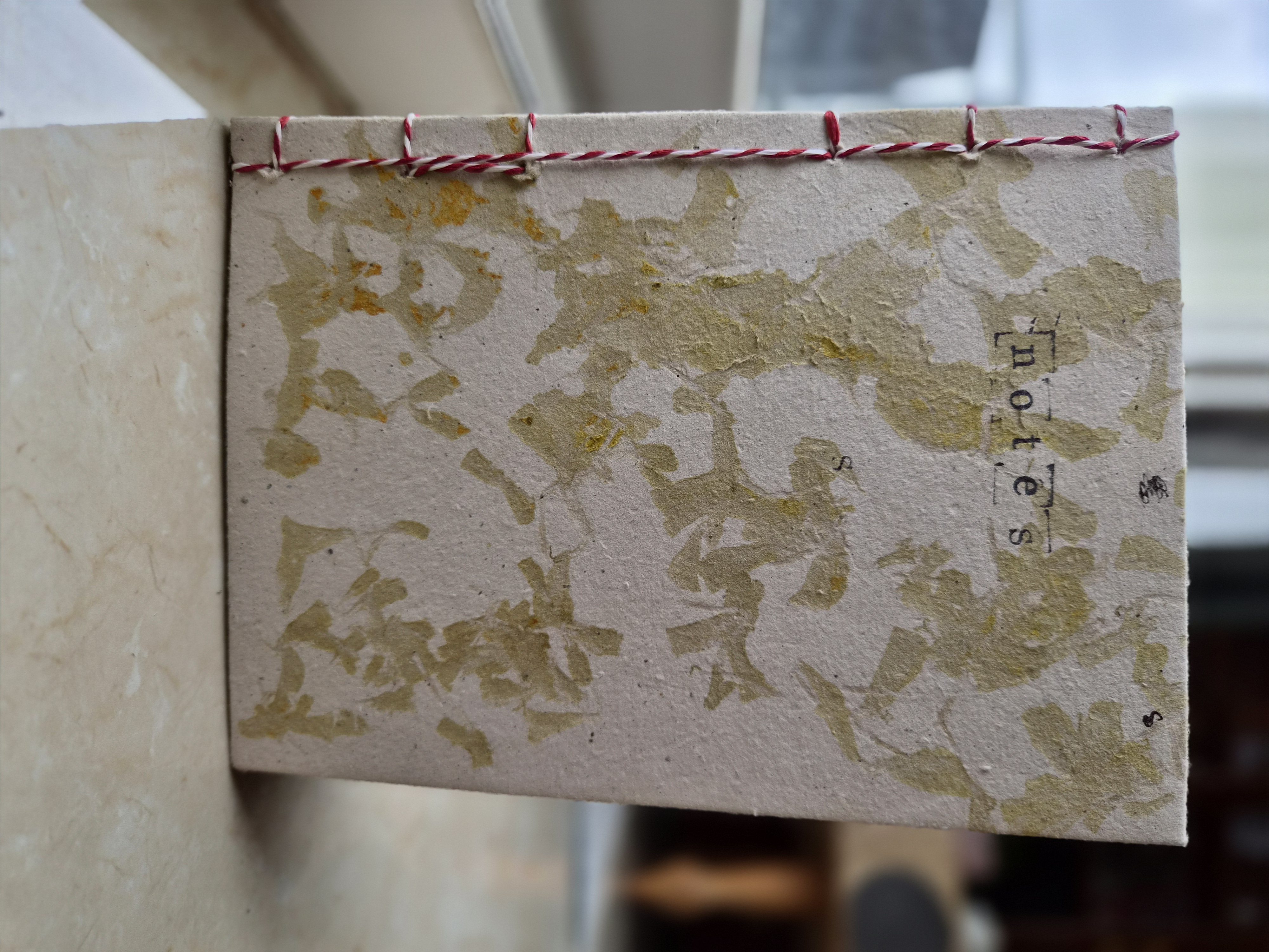 Green stitched handmade paper journal — hero